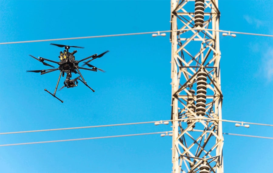 image of drone flying along powerlines looking for issues