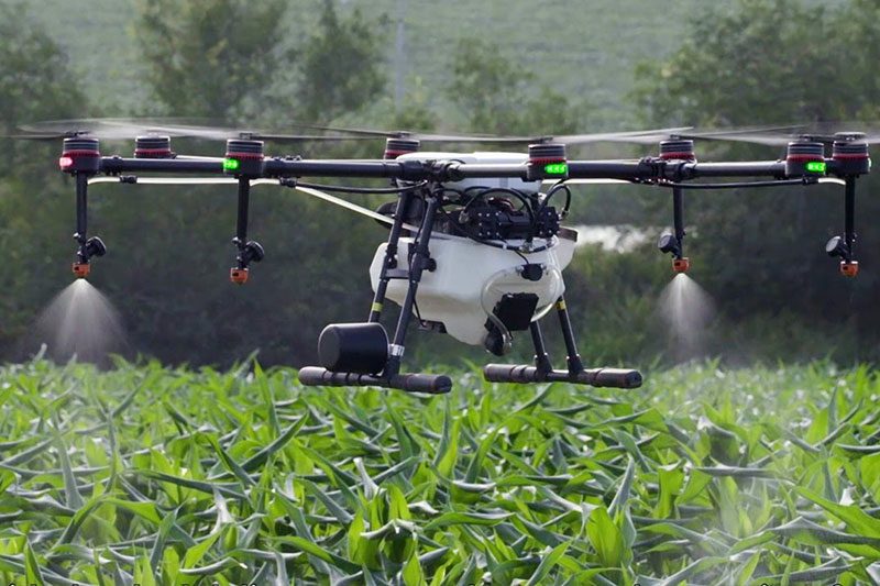 image of A Part 137 certified agricultural spray drone equipped with precision nozzles delivers targeted application over Florida farmland.